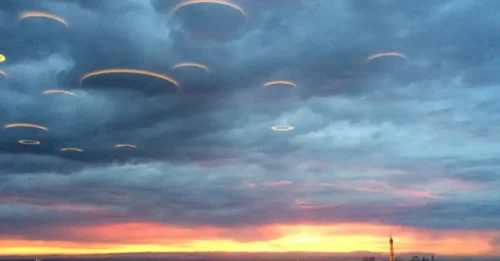 Among the clouds in the sky over the Russian River, a group of disc-shaped UFOs conceals itself
